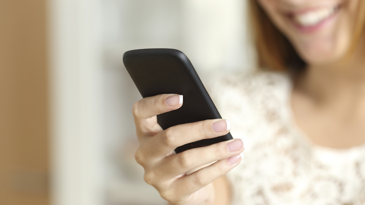Close up of a woman hand using a smart phone at home