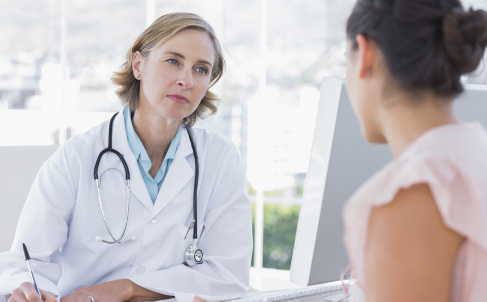 Doctor listening to her patient in the office