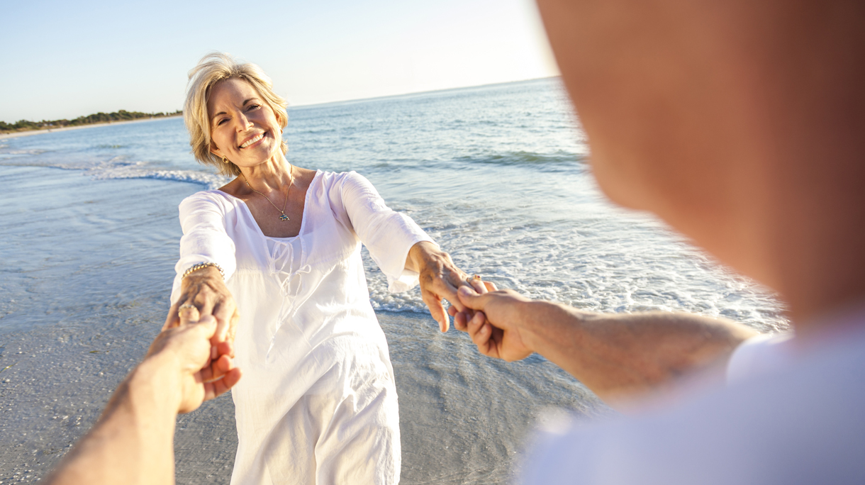 Happy Senior Couple Walking Holding Hands Tropical Beach