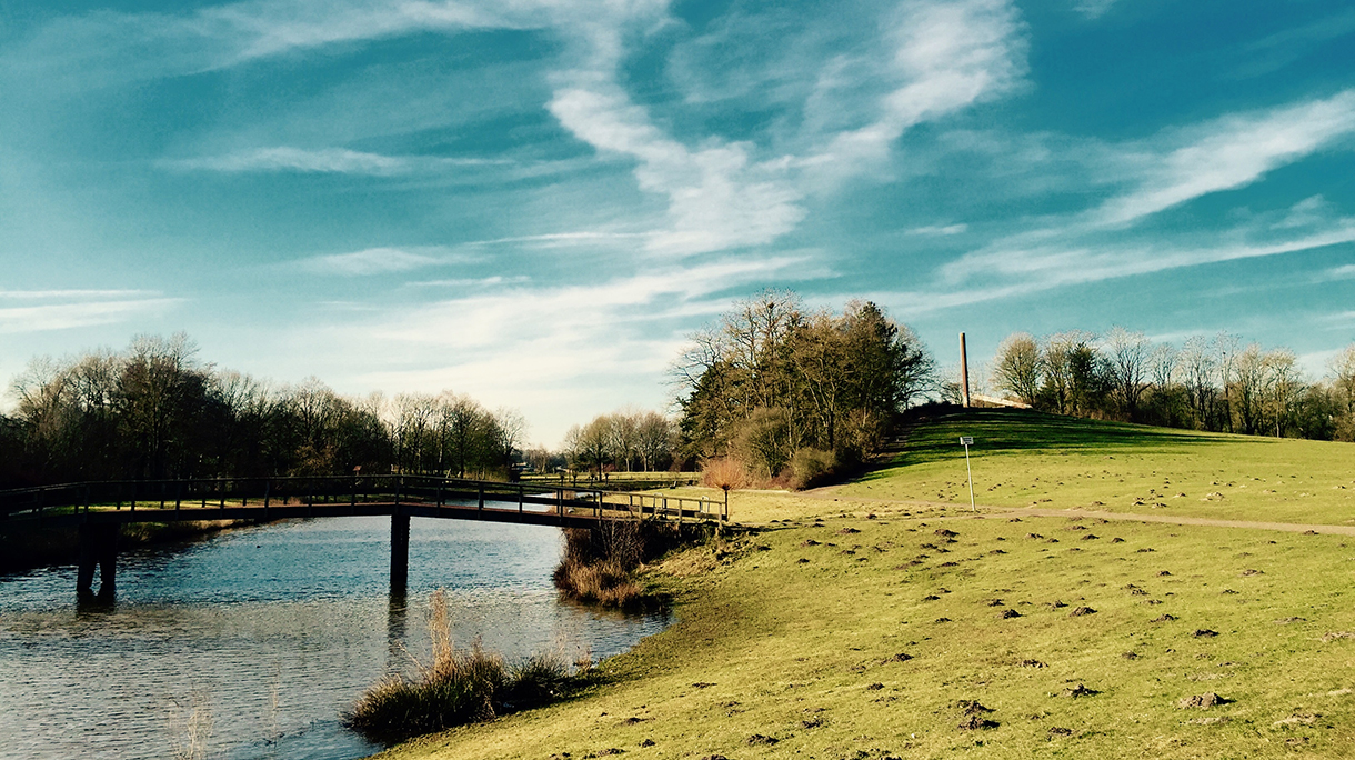 Green hill in a park with a pond in Enschede