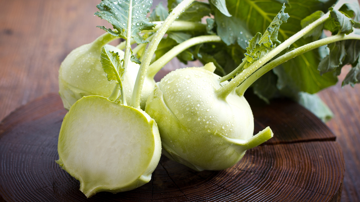 Fresh kohlrabi on the wooden table closeup