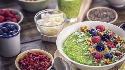 Green Breakfast Smoothie in Bowl with Superfoods on Top