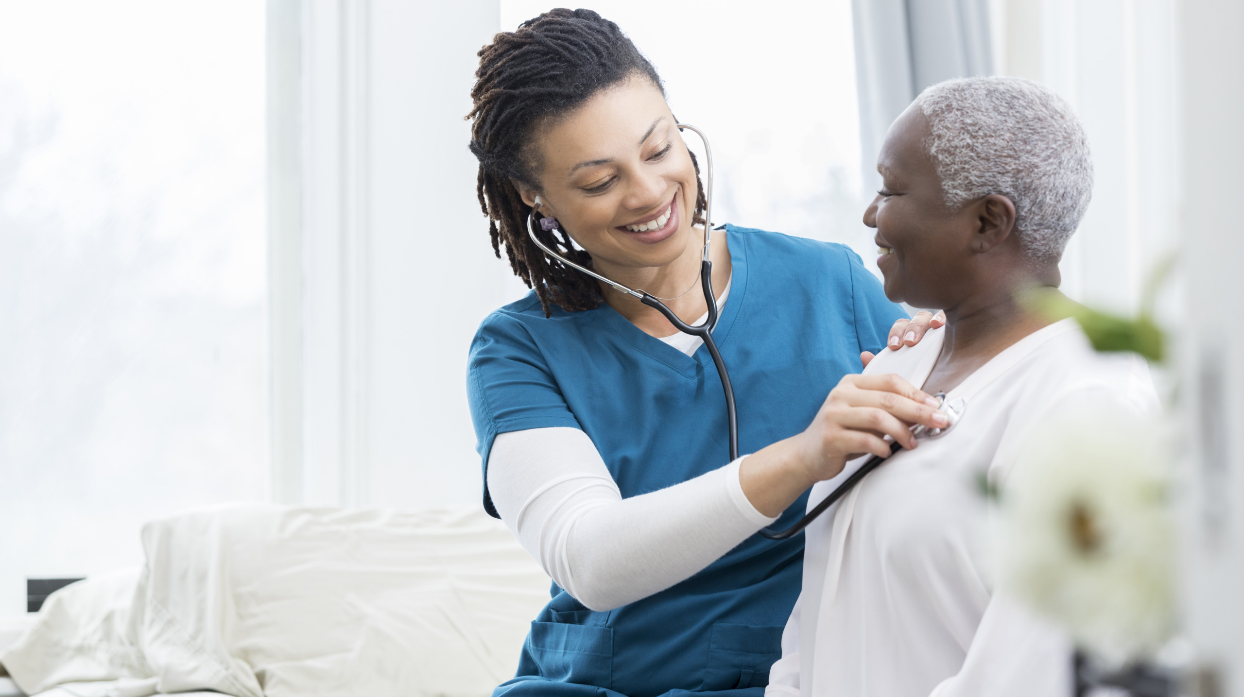 Female nurse checks patient’s vital signs