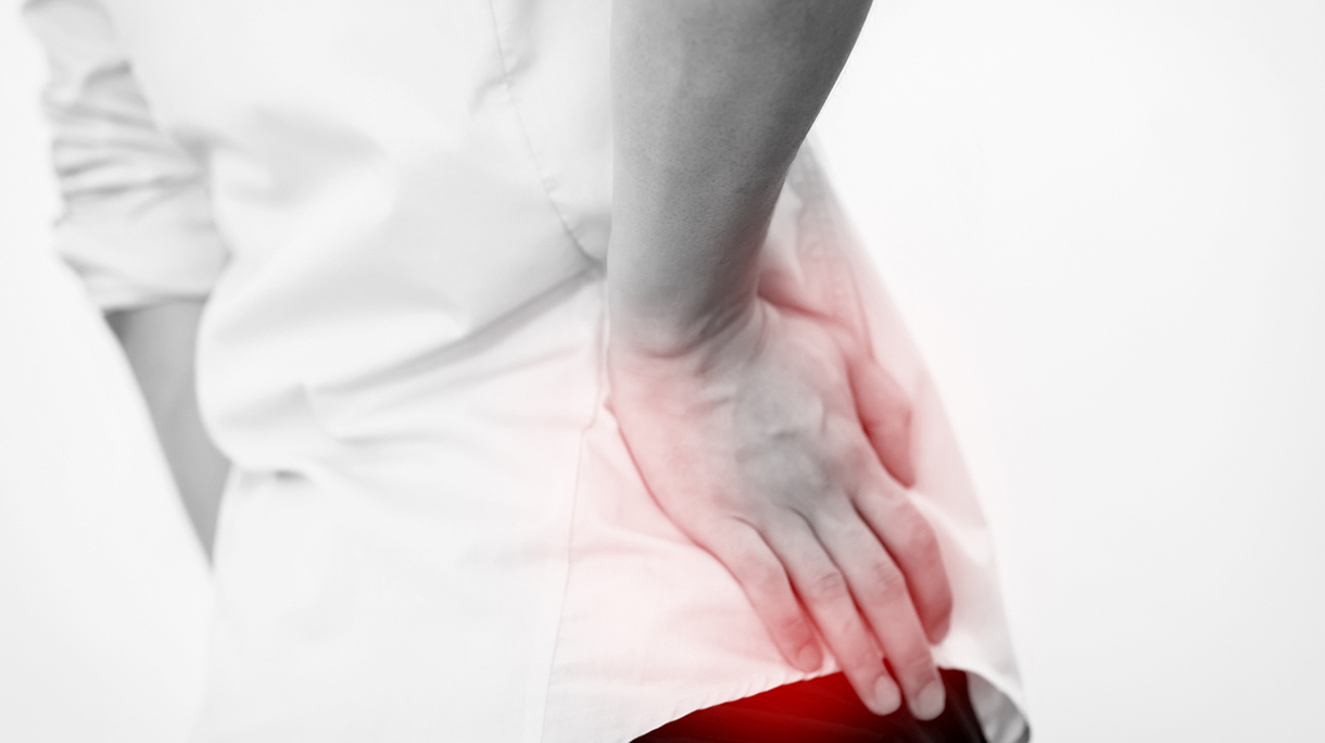 Young man in casual office shirt having hip pain