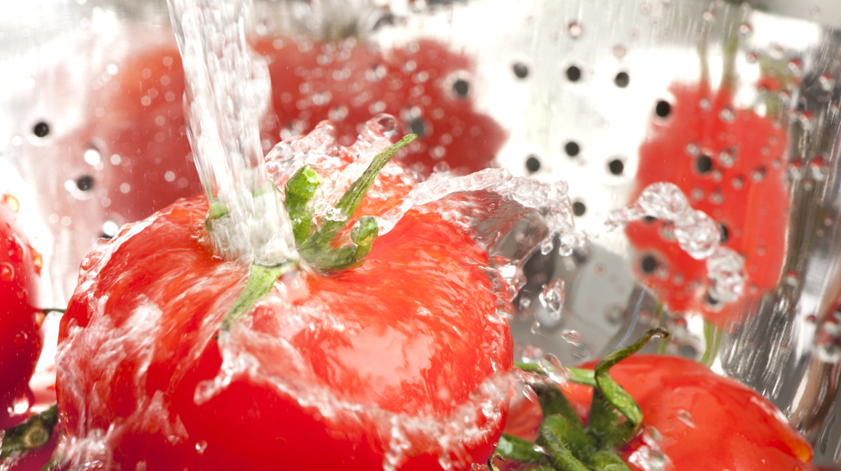 Close up of tomatoes being washed