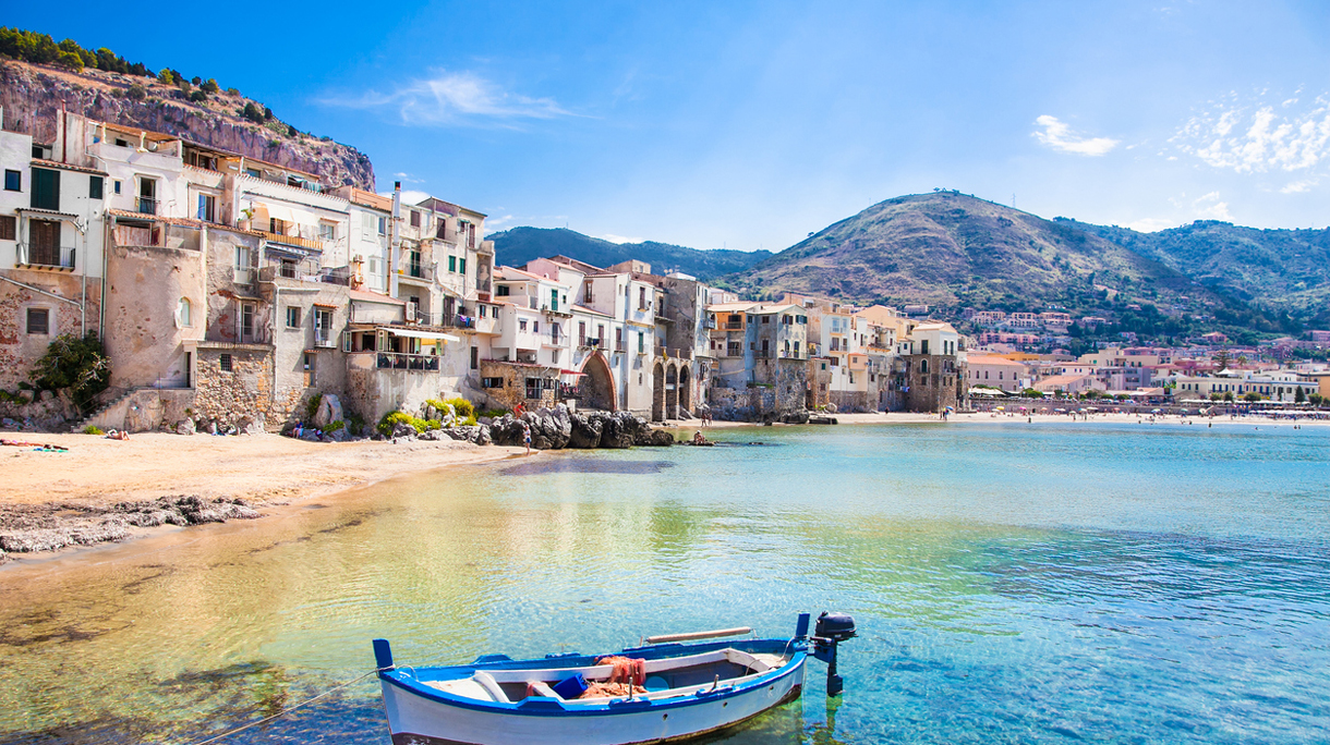 Old harbor with wooden fishing boat in Cefalu, Sicily