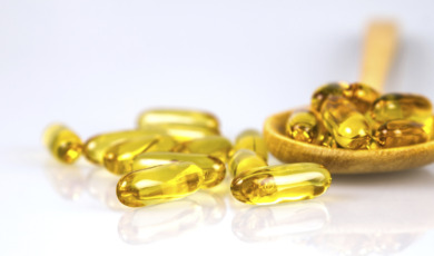 Closeup yellow soft gelatin supplement fish oil capsule