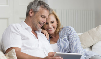 Happy Mature Couple With Tablet