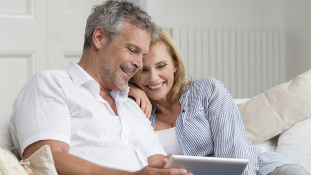 Happy Mature Couple With Tablet