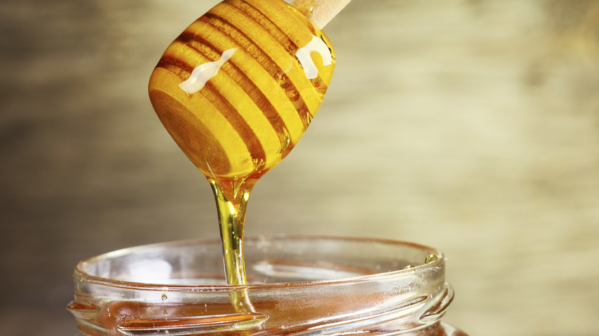 jar of honey with honeycomb