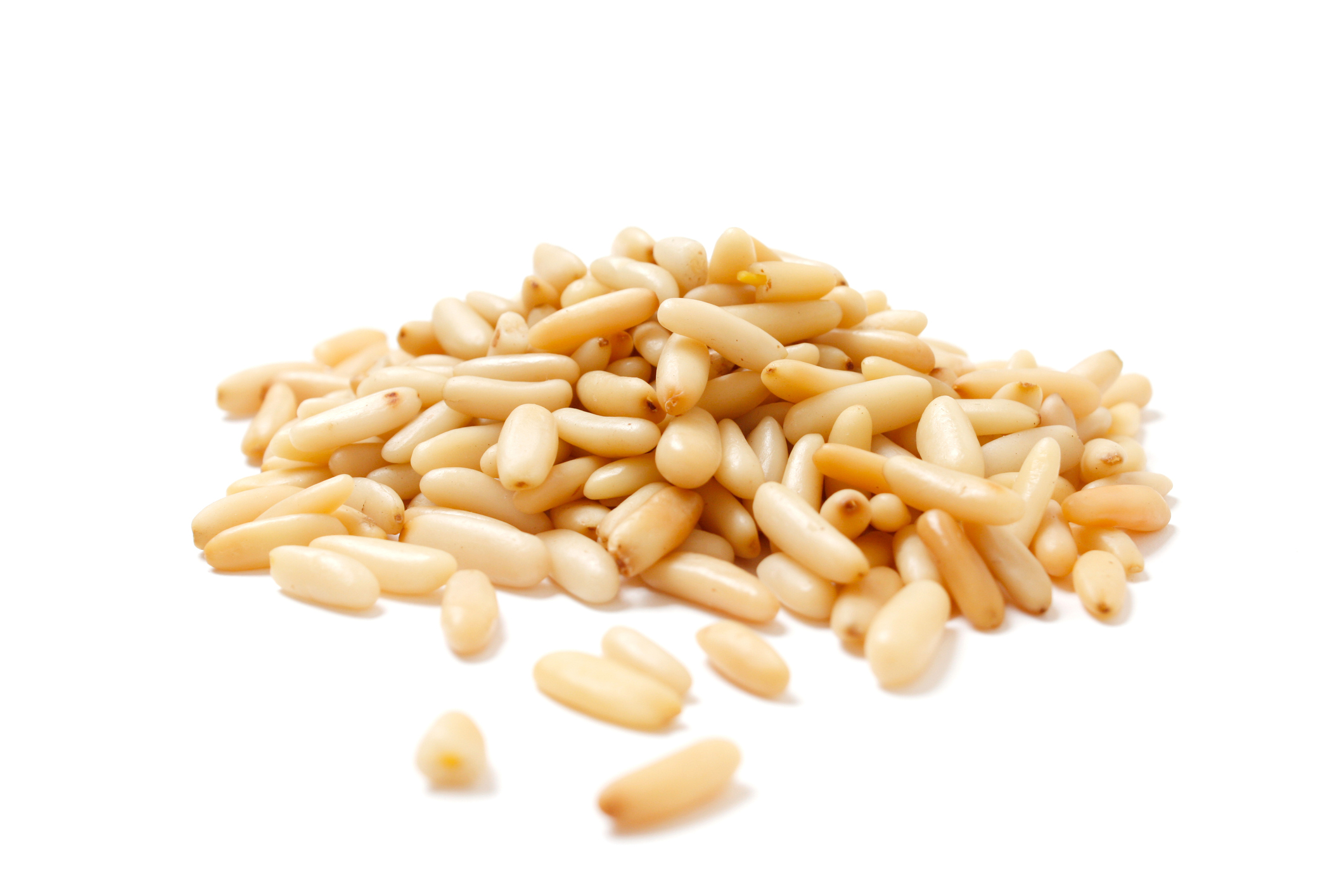 A large group of pine nuts in a pile