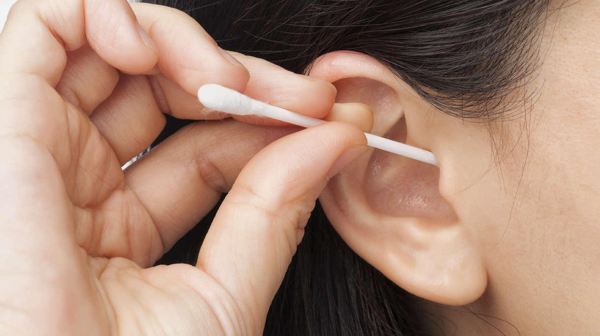 Woman cleaning ear
