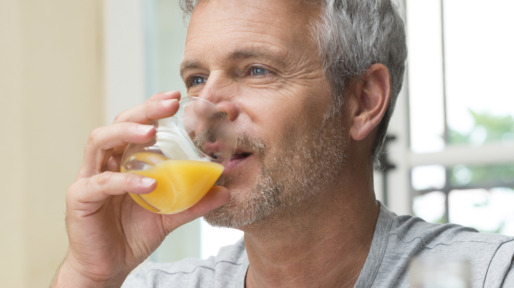 Mature Man Drinking Orange Juice