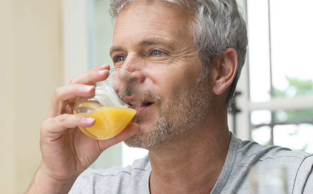 Mature Man Drinking Orange Juice