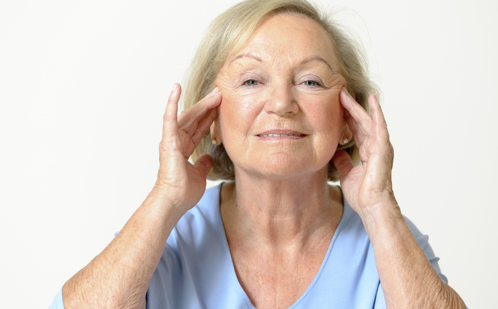 Senior woman showing her face, effect of aging