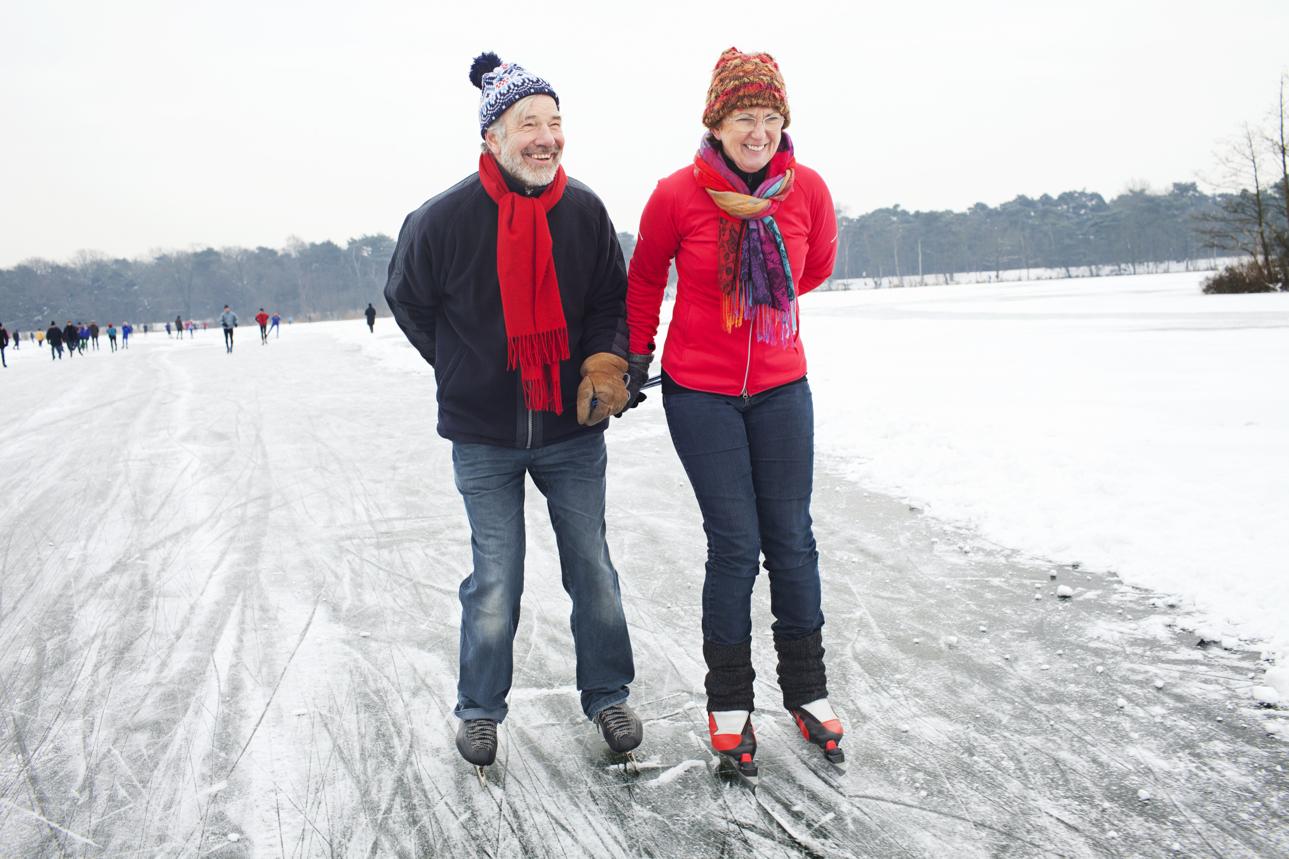 Couple ice skating, holding hands