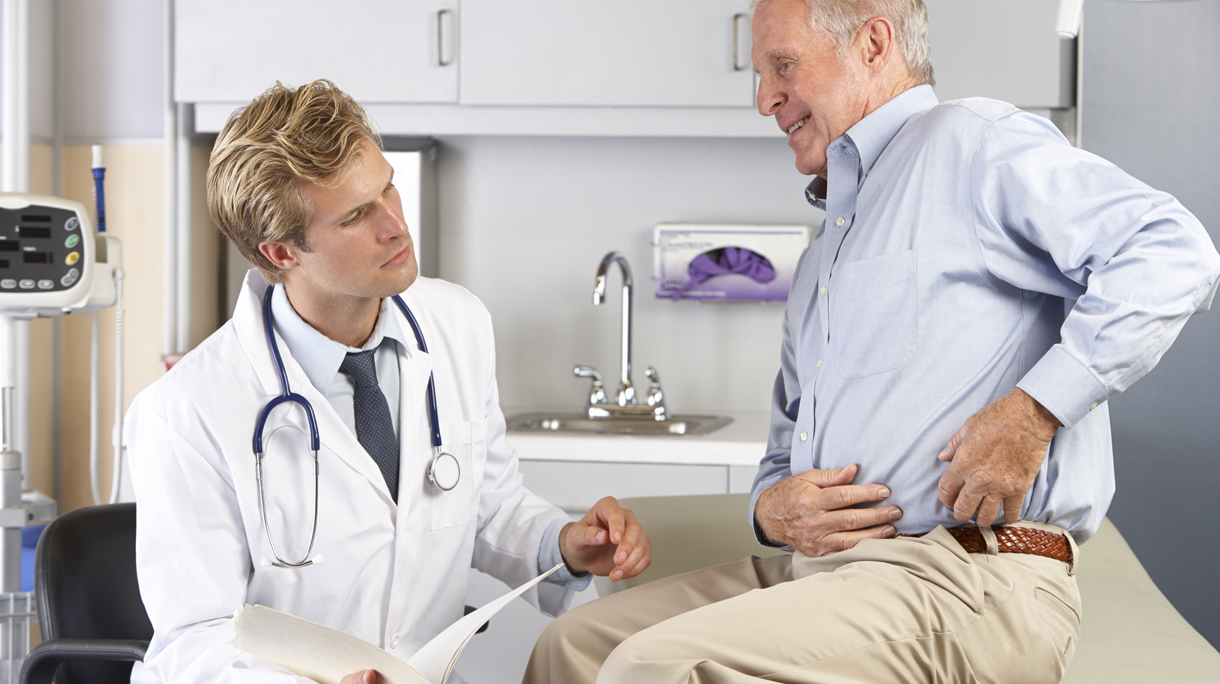 Doctor Examining Male Patient With Hip Pain