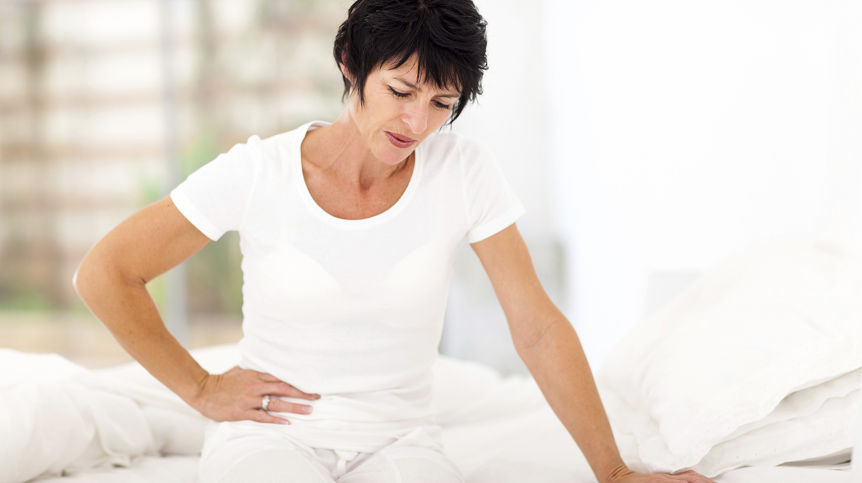 mature woman having stomach ache