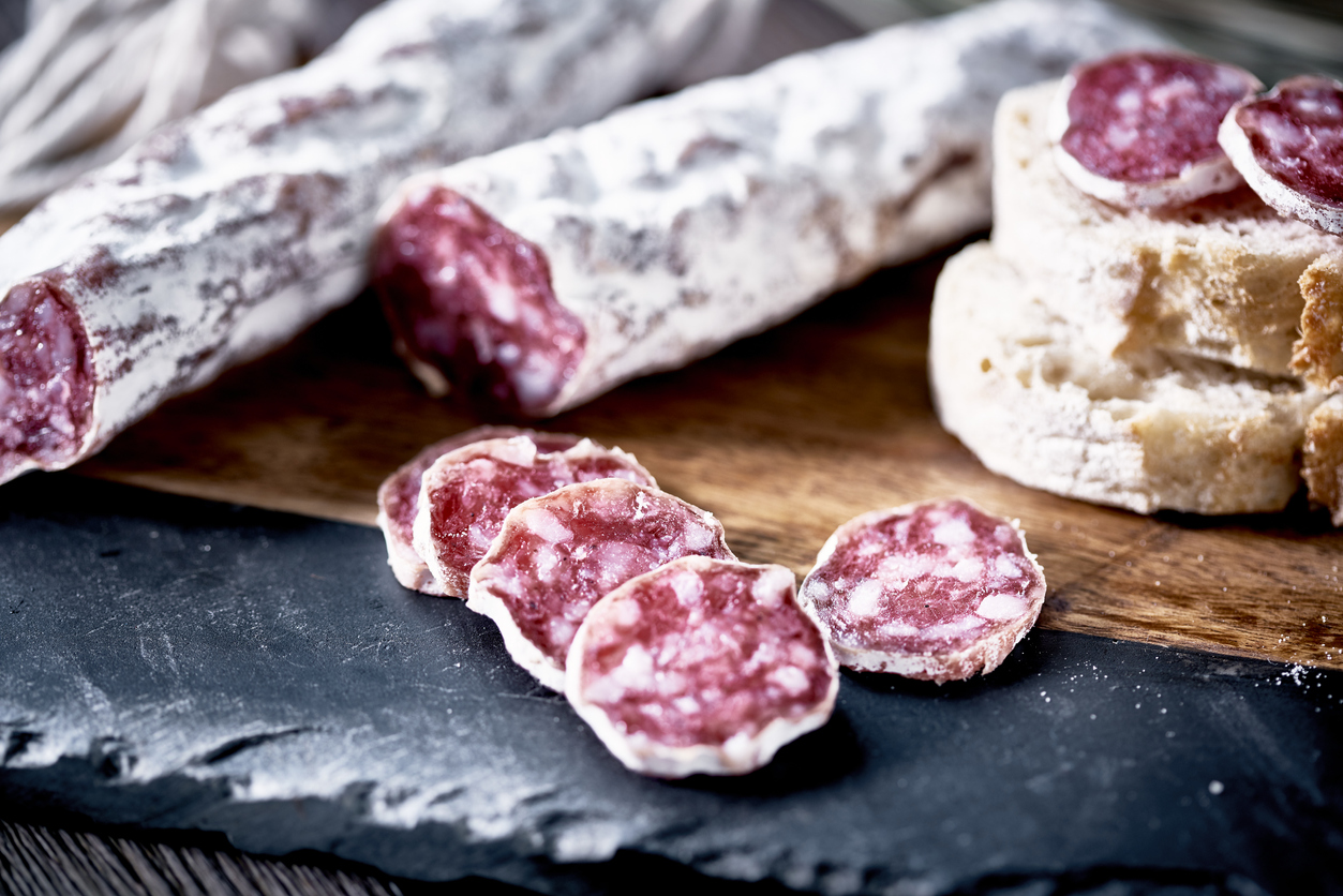 Slices of fuet salami with baguette