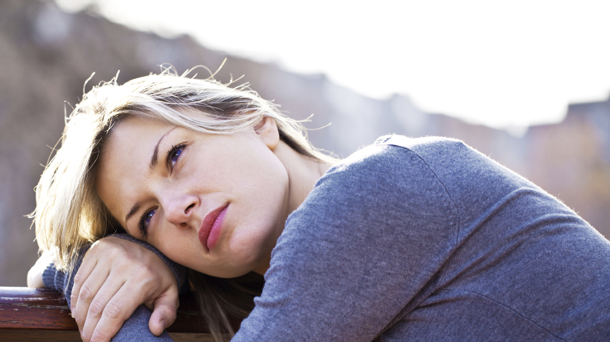 Portrait of beautiful woman leaned on the bench.