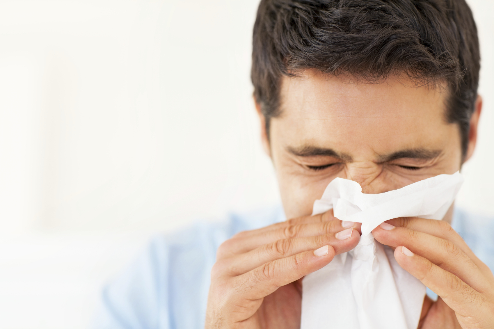 Young Man Blowing Nose