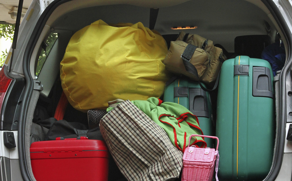 car full of luggage bags and travel bags