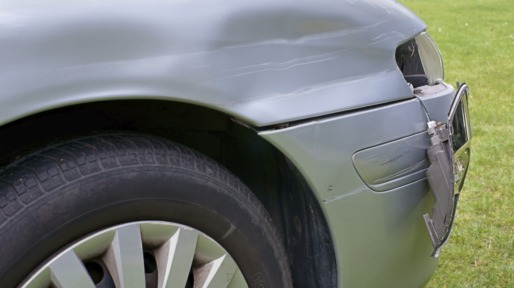 Car crash, the vehicle with a damaged fender, bumper and blinker
