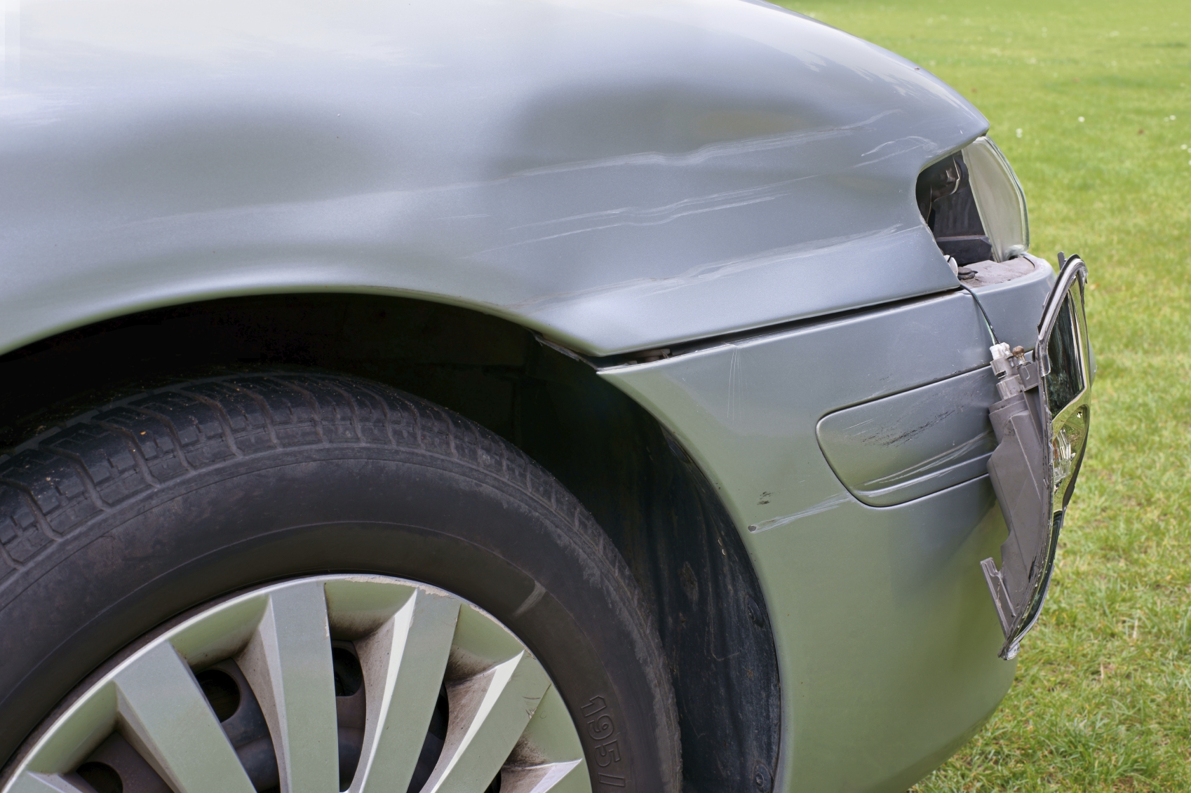 Car crash, the vehicle with a damaged fender, bumper and blinker