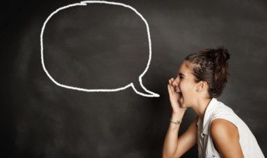 portrait of young girl with speech bubble on chalkboard