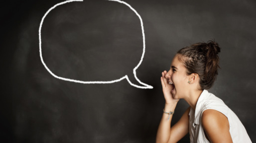 portrait of young girl with speech bubble on chalkboard