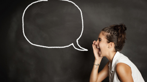 portrait of young girl with speech bubble on chalkboard