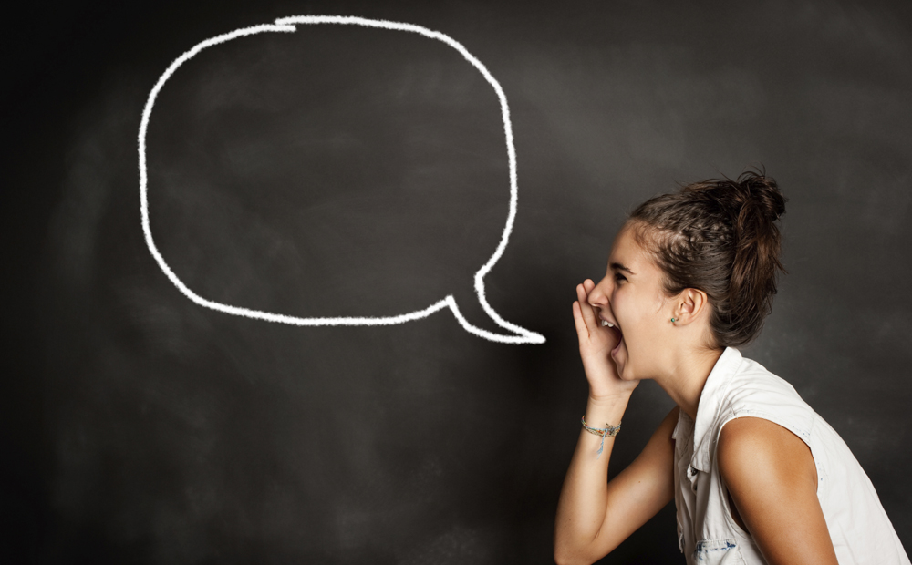 portrait of young girl with speech bubble on chalkboard