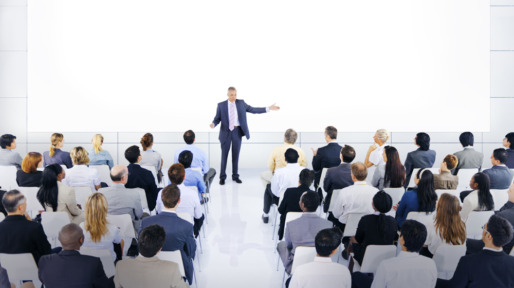 Group Of Business People Listening To A Speech