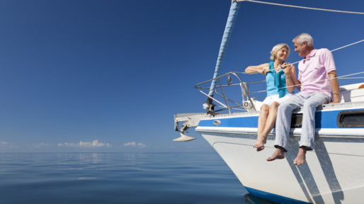 Happy Senior Couple on the Bow of a Sail Boat