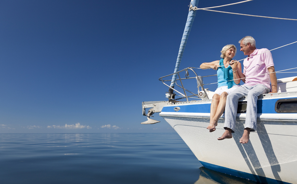 Happy Senior Couple on the Bow of a Sail Boat