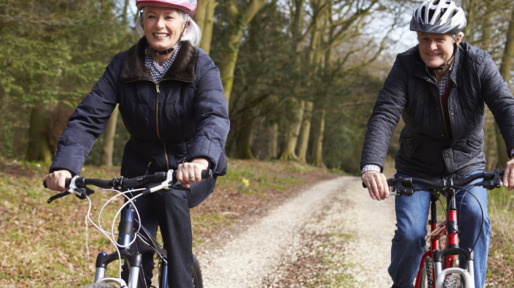 Senior Couple On Cycle Ride In Winter Countryside