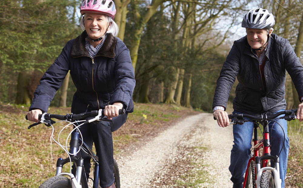 Senior Couple On Cycle Ride In Winter Countryside