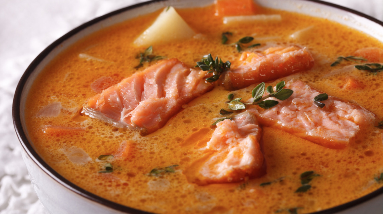 rich-salmon-soup-with-thyme-macro-in-a-white-bowl-picture-id611753958
