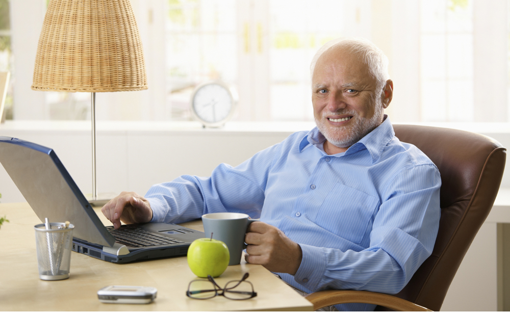 Portrait of happy senior man with computer