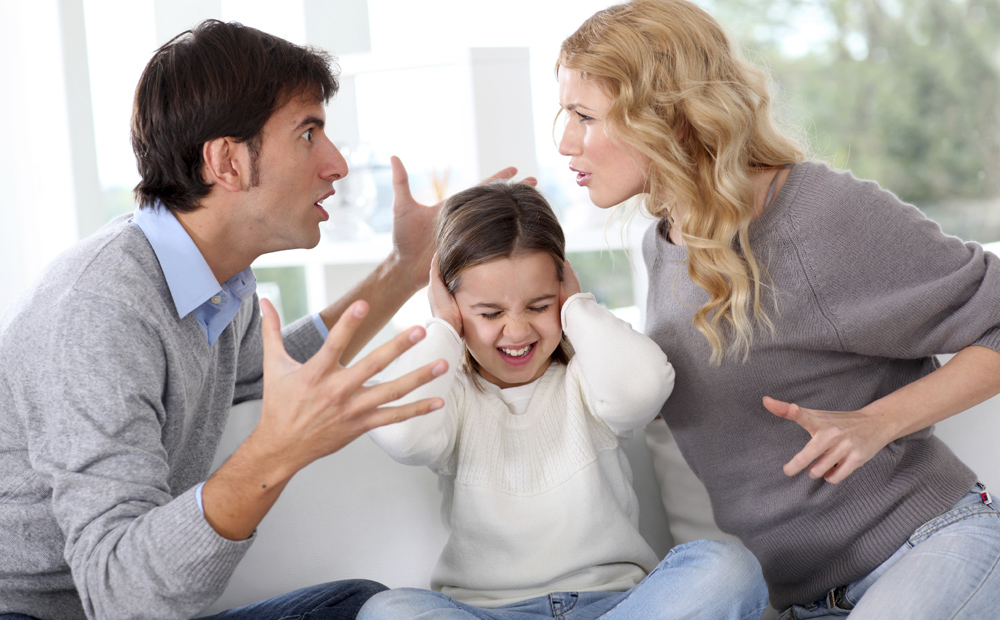 Couple fighting in front of child