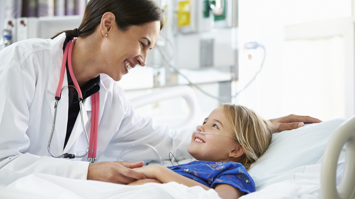 Young Girl Talking To Female Doctor In Intensive Care Unit