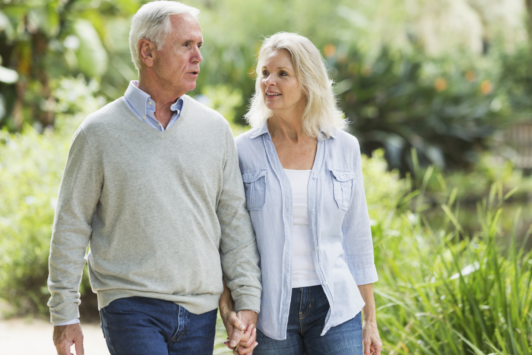 Portrait of senior couple walking in the park