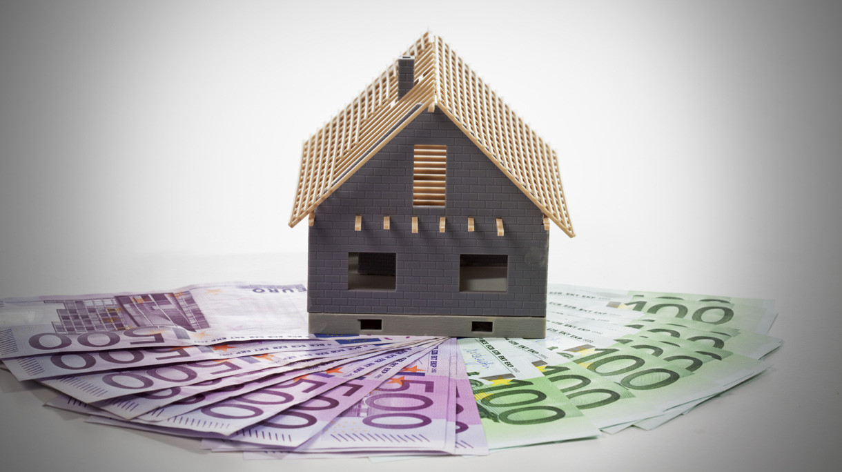 Model house on fanned euro notes