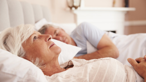 Worried Senior Woman Lying Awake In Bed