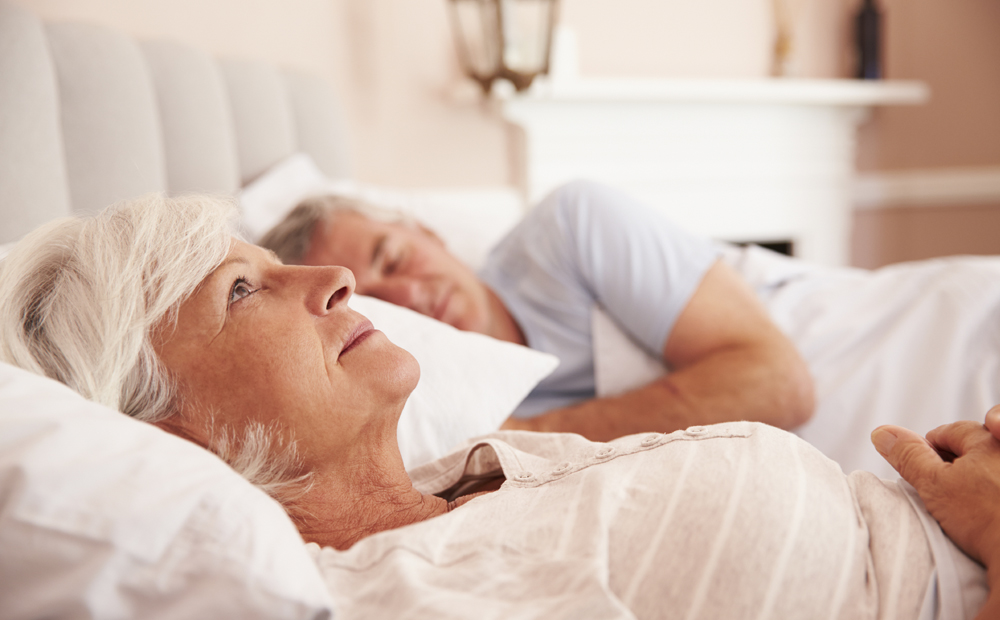 Worried Senior Woman Lying Awake In Bed