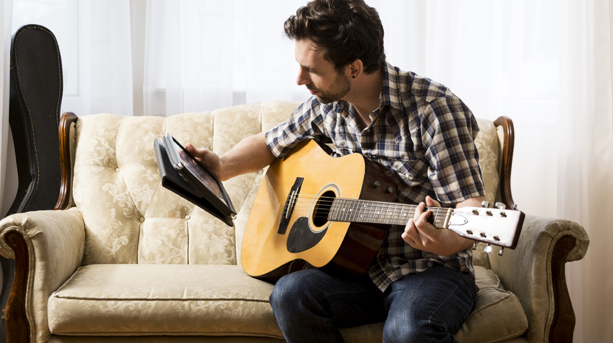Man with Tablet and Guitar