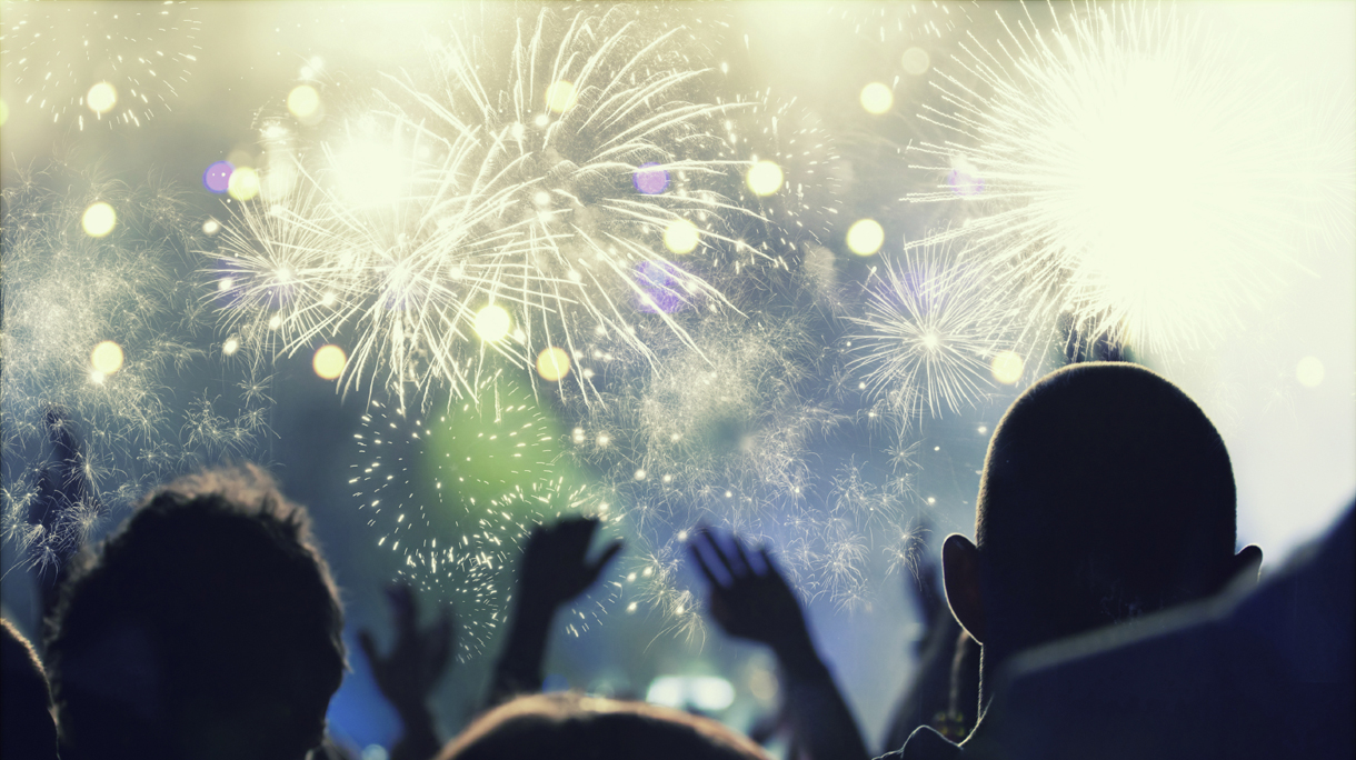 New Year concept – cheering crowd and fireworks