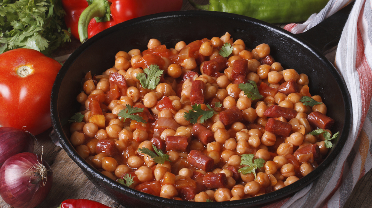 Chickpeas with chorizo in a frying pan and the ingredients