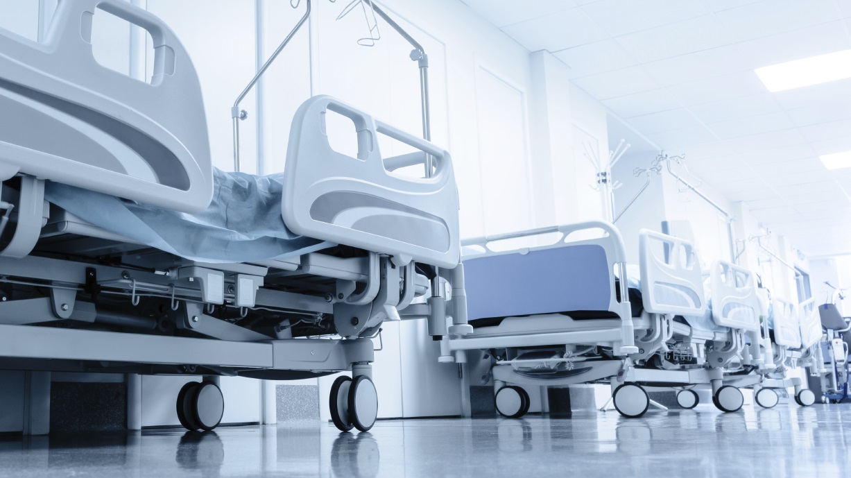long corridor in hospital with surgical beds.