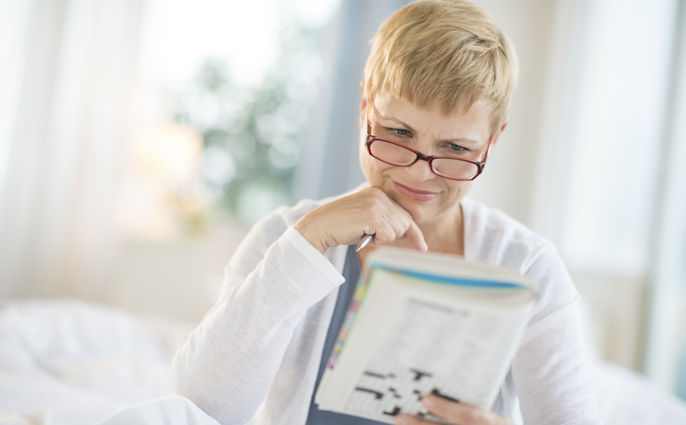 Woman Reading Book In Bedroom